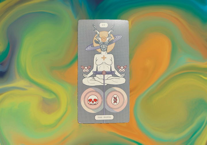 A tarot card showing The Devil (XV) with a horned figure above a seated meditating person, flanked by two circular symbols containing a skull and DNA helix, on a swirling colorful background.
